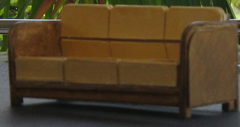 An photo of an old sofa in a model box