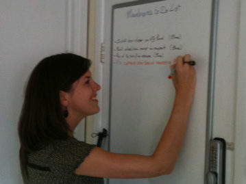 A photo of Watermill staff member Becky writing on a whiteboard